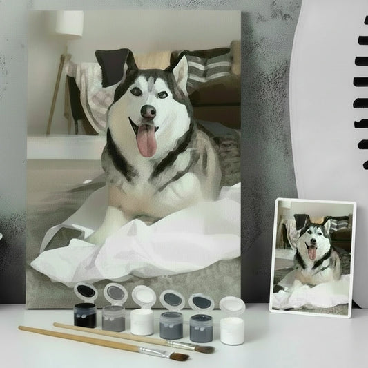 Framed photo of a husky dog on a gray surface with plants and a gray wall.