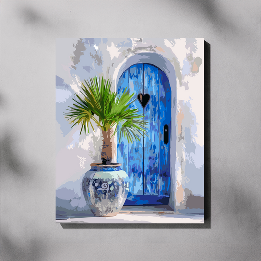 A canvas paint by number depicting a blue arched door with a small potted palm in a ceramic pot, shown hanging on a light gray wall with soft shadow overlays.