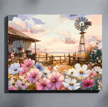 Cosmos Farmyard paint by number kit — completed canvas mockup of a watercolour farm scene with cosmos flowers in pink, white and lavender, a weathered barn, windmill and golden plains at sunrise
