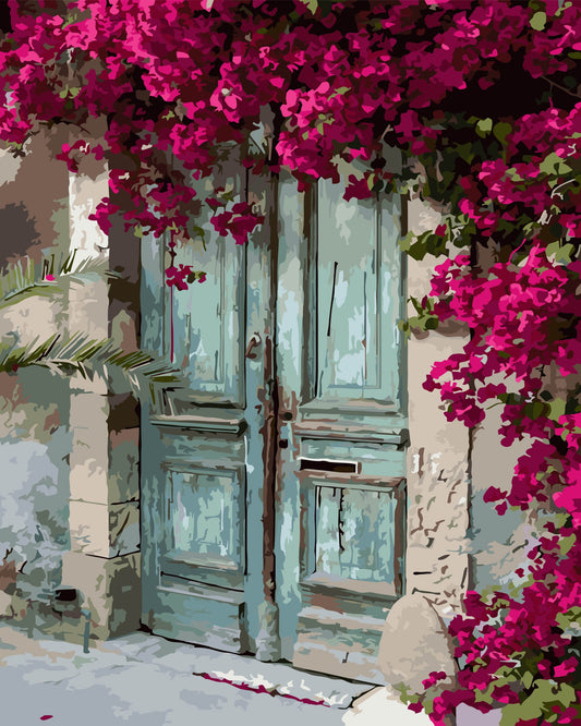 Old wooden door with pink flowers above it