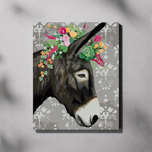 A square canvas paint by number featuring a stylized donkey head with a colorful floral crown, shown hanging against a light gray wall with soft shadow overlays.