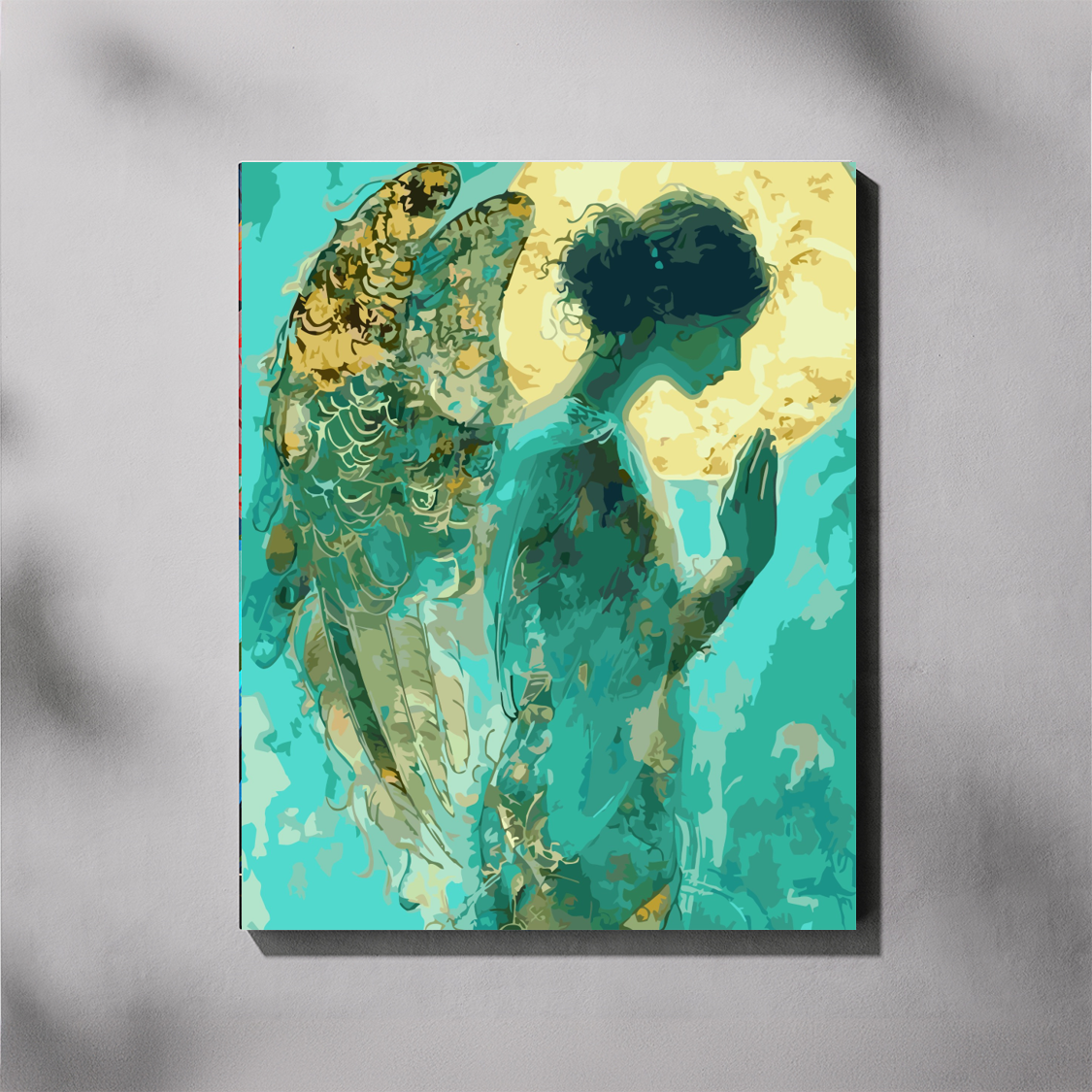 Guardian angel paint by number kit — completed canvas mockup of a praying angel with teal and gold tones against a luminous moon halo background