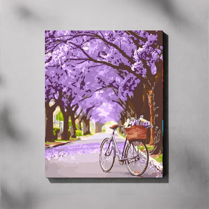 Canvas paint by number of a bicycle under a canopy of purple jacaranda trees on a gray background