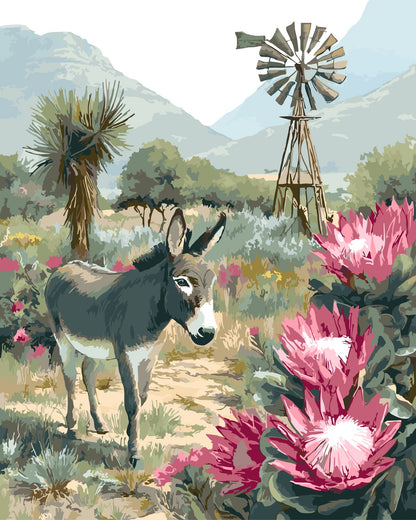 Donkey in a Karoo landscape with pink flowers and a windmill