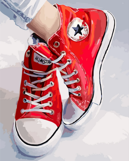 Red high-top sneakers with white laces on a light gray background