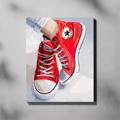 Red high-top sneakers with white soles on a light gray background