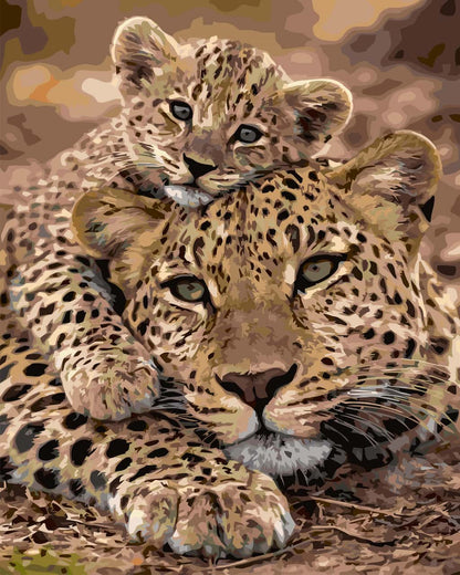 A close-up paint by number of a leopard mother and cub resting together, with the cub perched on the mother's head. The artwork uses warm tan, brown, black, and cream tones, and the animal faces are rendered in a painterly style.