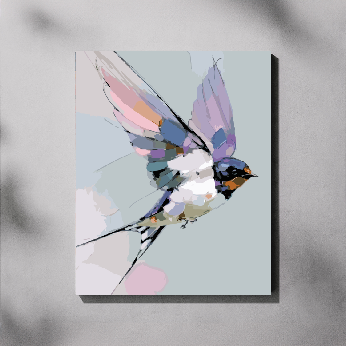 Pastel Swallow paint by number kit — completed canvas mockup of a barn swallow in flight painted in soft lavender, blush pink and dusty blue on a sage green background
