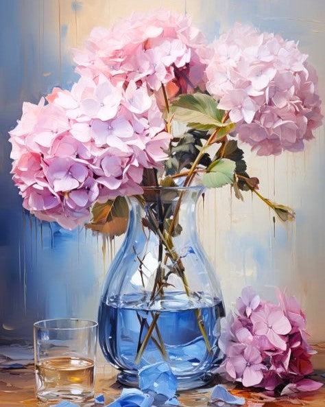 Pink hydrangeas in a clear glass vase on a wooden surface with a blurred background