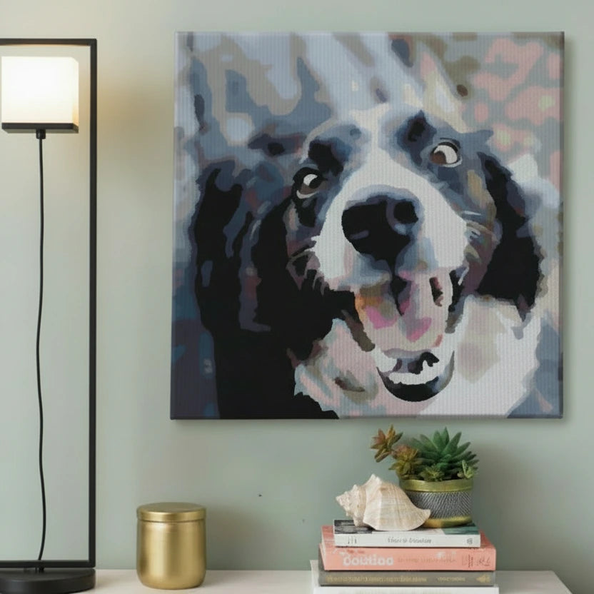 Stylised persoanlised paint by number canvas of a dog's face on a wall above a lamp and books.