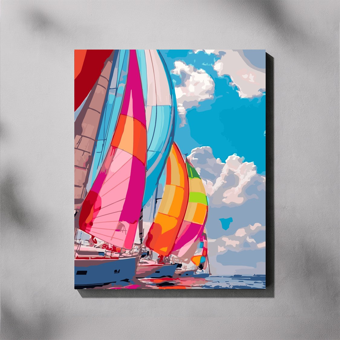 Colorful sailboats against a blue sky with white clouds