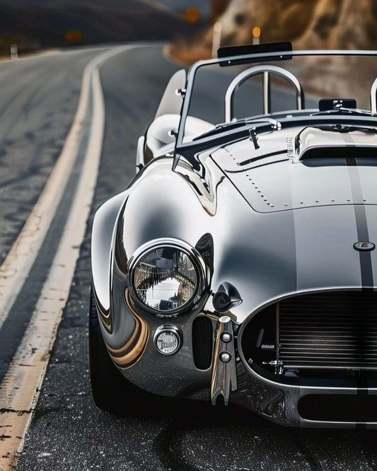Vintage car on a road with a scenic background