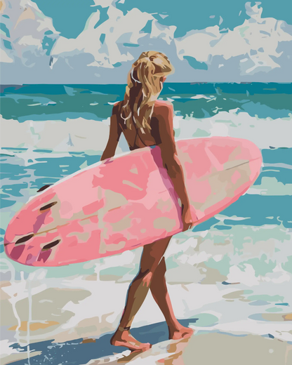 Woman holding a pink surfboard on a beach with ocean waves in the background