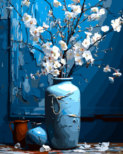 Blue vase with white flowers against a blue background