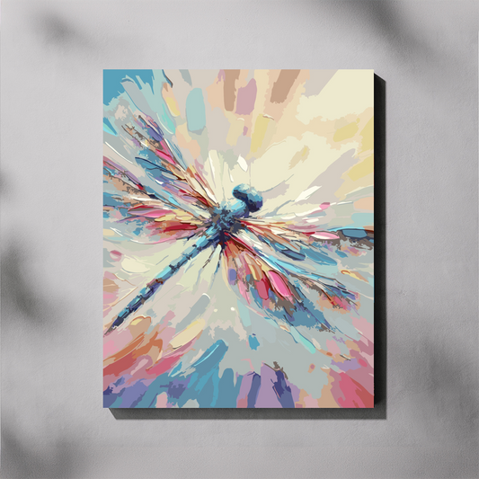 Abstract paint by number featuring a dragonfly in blue with pink, purple, and orange wing details on a soft pastel background, shown hanging on a light gray wall.