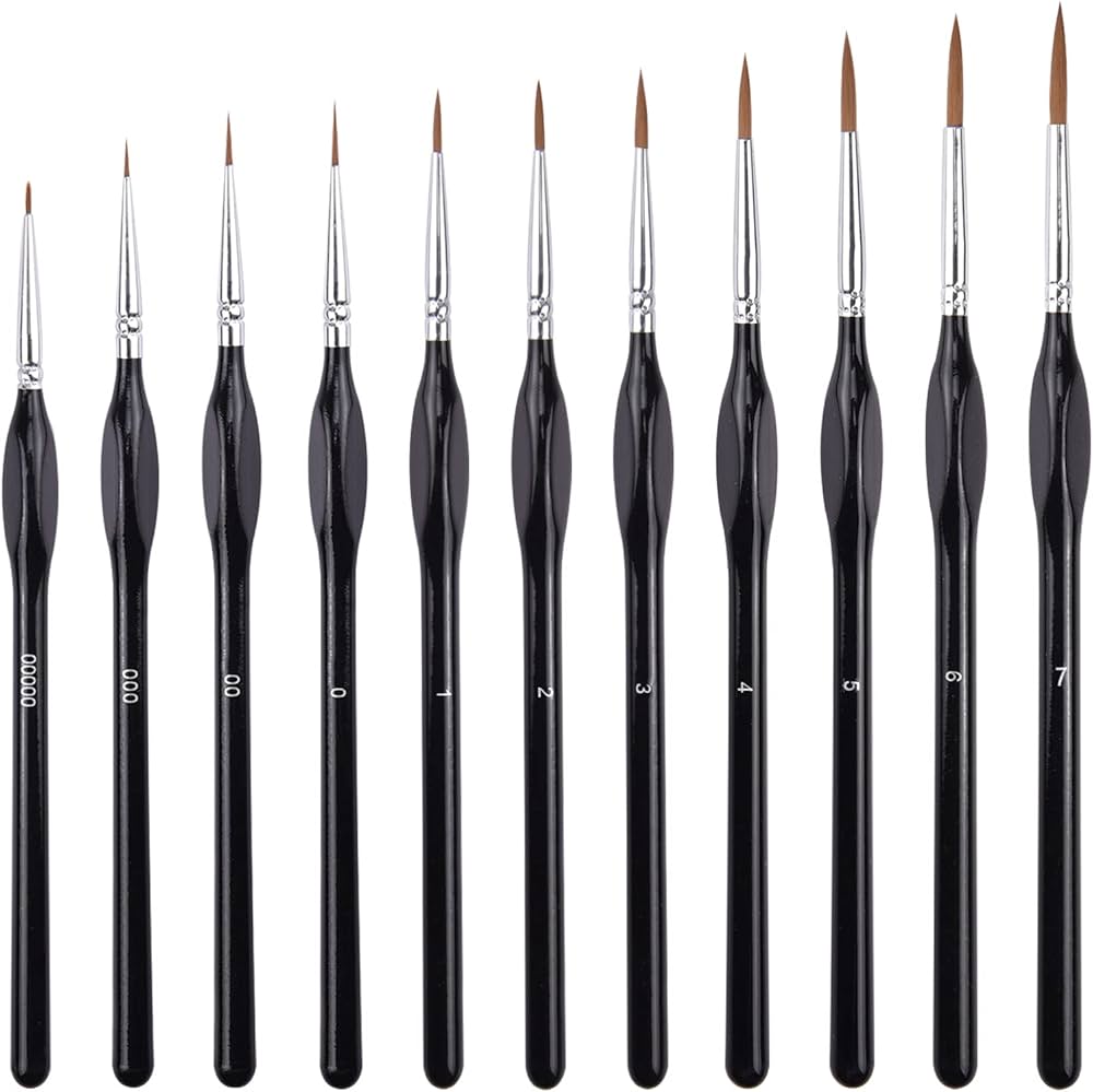 Set of black paintbrushes with silver ferrules on a white background