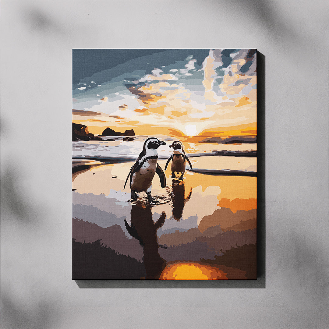 Canvas print of two penguins on a beach at sunset.