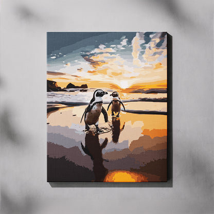 Canvas print of two penguins on a beach at sunset.