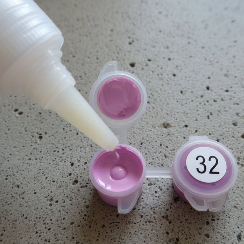 Pink containers with a white label reading '32' on a speckled surface.