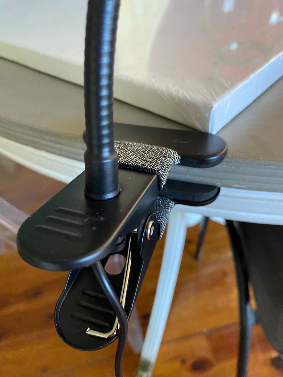 Black adjustable clip attached to a table