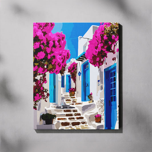 Canvas print of a colorful street scene with white buildings, blue doors, and pink flowers on a gray background.