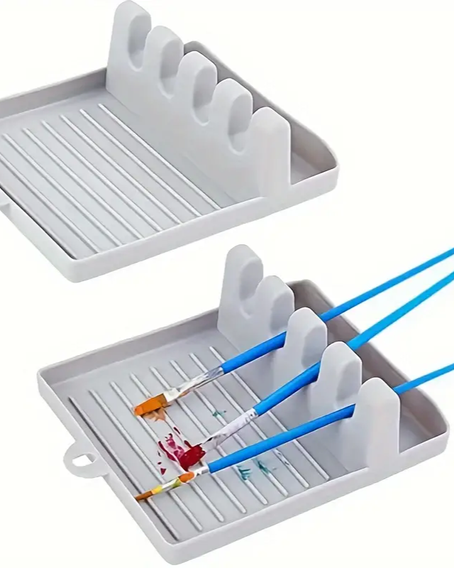 Gray paintbrush holder with paintbrushes and paint on a white background