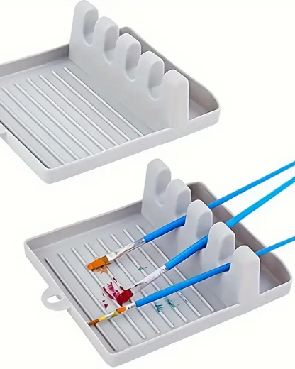Gray paintbrush holder with paintbrushes and paint on a white background