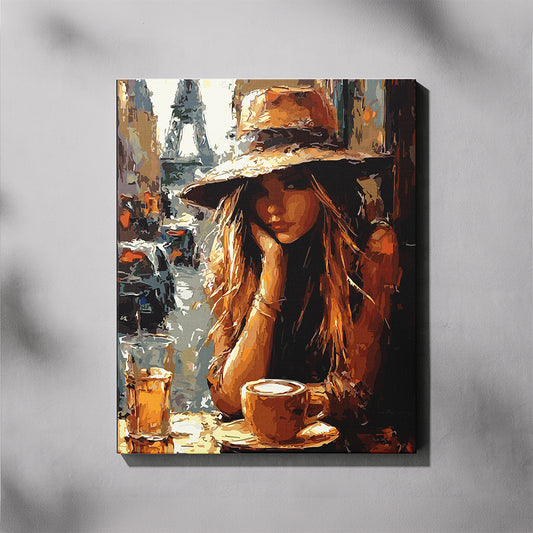 Paris Café paint by number kit — completed canvas mockup of a woman in a wide-brim hat seated at a Parisian café in rich amber and caramel tones
