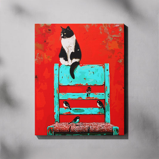 Canvas print of a black and white cat on a blue chair with birds on a red background