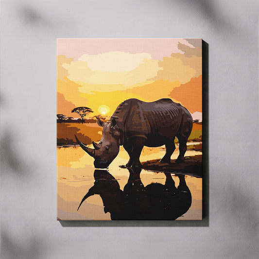 Canvas print of a rhino in a sunset landscape with reflection