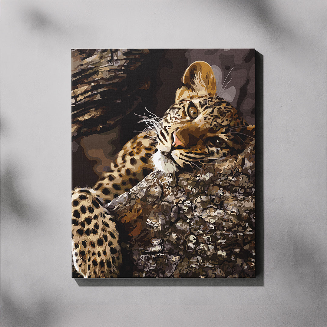 Canvas paint by number of a leopard on a tree branch against a gray background