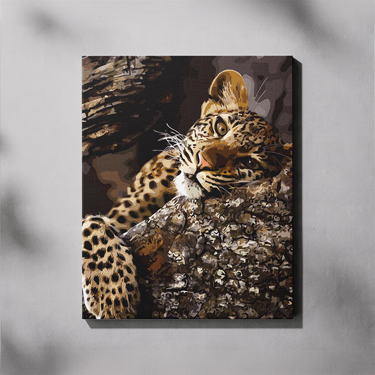 Canvas paint by number of a leopard on a tree branch against a gray background