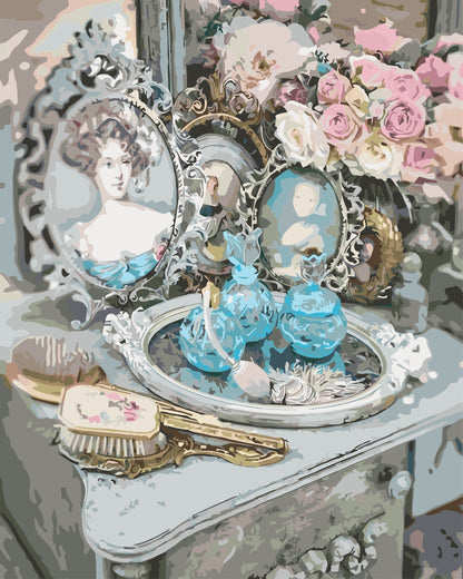 Vintage-style vanity with decorative mirrors, flowers, and small figurines on a table.