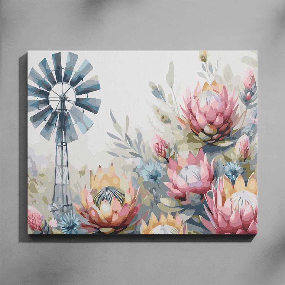 Windmill paint by number kit — completed canvas mockup of a steel windmill with blue fan blades surrounded by pink and yellow King Proteas and blue fynbos on a soft white background